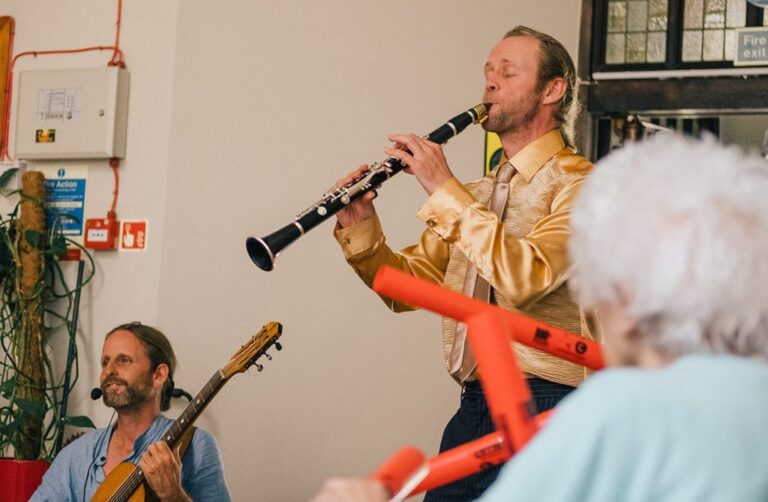 A man playing a clarinet and other instruments