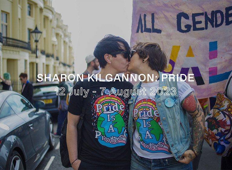 Two people kissing at Pride