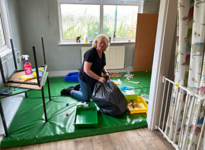 a lady cleaning out a room